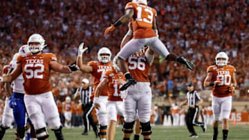 AUSTIN, TX - AUGUST 31: Zach Shackelford #56 of the Texas Longhorns lifts Brennan Eagles #13 after a touchdown reception in the second quarter against the Louisiana Tech Bulldogs at Darrell K Royal-Texas Memorial Stadium on August 31, 2019 in Austin, Texas. (Photo by Tim Warner/Getty Images)