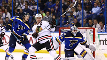 Nov 9, 2016; St. Louis, MO, USA; Chicago Blackhawks center Jonathan Toews (19) is pressured by St. Louis Blues defenseman Jay Bouwmeester (19) as goalie Jake Allen (34) defends the net during the first period at Scottrade Center. Mandatory Credit: Billy Hurst-USA TODAY Sports