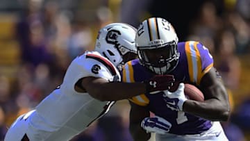 Leonard Fournette #7 of the LSU Tigers is pursued by Jonathan Walton #28 of the South Carolina Gamecocks. (Photo by Stacy Revere/Getty Images)