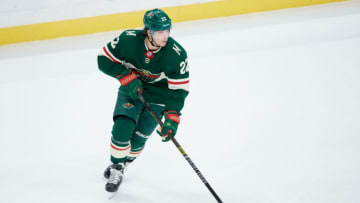 ST PAUL, MINNESOTA - JANUARY 05: Kevin Fiala #22 of the Minnesota Wild controls the puck against the Calgary Flames during the game at Xcel Energy Center on January 5, 2020 in St Paul, Minnesota. The Flames defeated the Wild 5-4 in a shootout. (Photo by Hannah Foslien/Getty Images)