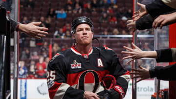 OTTAWA, ON - JANUARY 12: Fans reach out for a puck from Chris Neil