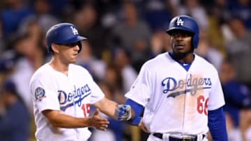 LOS ANGELES, CA - MAY 09: Austin Barnes #15 and Yasiel Puig #66 celebrate their runs from a Chase Utley #26 double to take a 6-3 lead during the eighth inning against the Arizona Diamondbacks at Dodger Stadium on May 9, 2018 in Los Angeles, California. (Photo by Harry How/Getty Images)
