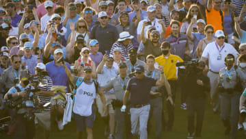 May 23, 2021; Kiawah Island, South Carolina, USA; Phil Mickelson and caddie Tim Mickelson walks though the crowd of fans on the 18th hole during the final round of the PGA Championship golf tournament. Mandatory Credit: Geoff Burke-USA TODAY Sports