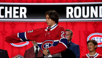 Jun 28, 2023; Nashville, Tennessee, USA; Montreal Canadians draft pick David Reinbacher puts on his sweater after being selected with the fifth pick in round one of the 2023 NHL Draft at Bridgestone Arena. Mandatory Credit: Christopher Hanewinckel-USA TODAY Sports