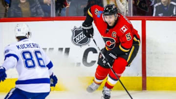 Jan 5, 2016; Calgary, Alberta, CAN; Calgary Flames defenseman Mark Giordano (5) controls the puck against the Tampa Bay Lightning during the third period at Scotiabank Saddledome. Calgary Flames won 3-1. Mandatory Credit: Sergei Belski-USA TODAY Sports