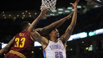 Feb 26, 2014; Oklahoma City, OK, USA; Oklahoma City Thunder shooting guard Thabo Sefolosha (25) attempts a shot against Cleveland Cavaliers small forward Alonzo Gee (33) during the fourth quarter at Chesapeake Energy Arena. Mandatory Credit: Mark D. Smith-USA TOD