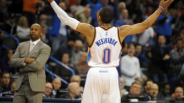Feb 22, 2015; Oklahoma City, OK, USA; Oklahoma City Thunder guard Russell Westbrook (0) reacts after a play against the Denver Nuggets at Denver Nuggets head coach Brian Shaw looks on during the second quarter at Chesapeake Energy Arena. Mandatory Credit: Mark D. Smith-USA TODAY Sports