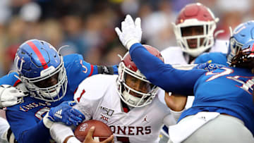 LAWRENCE, KANSAS - OCTOBER 05: Quarterback Jalen Hurts #1 of the Oklahoma Sooners is tackled by linebacker Azur Kamara #5 of the Kansas Jayhawks during the game at Memorial Stadium on October 05, 2019 in Lawrence, Kansas. (Photo by Jamie Squire/Getty Images)