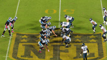 CHARLOTTE, NC - OCTOBER 25: Cam Newton #1 of the Carolina Panthers takes a snap over the gold NFL logo at midfield against the Philadelphia Eagles at Bank Of America Stadium on October 25, 2015 in Charlotte, North Carolina. (Photo by Scott Cunningham/Getty Images)
