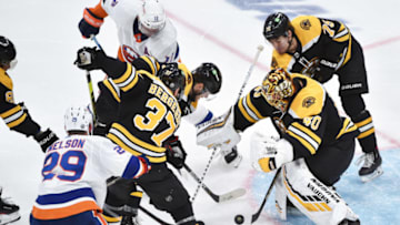 May 31, 2021; Boston, Massachusetts, USA; Boston Bruins goaltender Tuukka Rask (40) looks for the loose puck in from of center Patrice Bergeron (37) and New York Islanders center Brock Nelson (29) overtime in game two of the second round of the 2021 Stanley Cup Playoffs at TD Garden. Mandatory Credit: Bob DeChiara-USA TODAY Sports