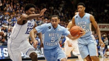 Feb 18, 2015; Durham, NC, USA; North Carolina Tar Heels guard Marcus Paige (5) drives past Duke Blue Devils forward Justise Winslow (12) in their game at Cameron Indoor Stadium. Mandatory Credit: Mark Dolejs-USA TODAY Sports