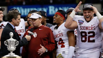 NEW ORLEANS, LA - JANUARY 02: Head coach Bob Stoops of the Oklahoma Sooners celebrates with his team and the winner's trophy after defeating the Alabama Crimson Tide 45-31 during the Allstate Sugar Bowl at the Mercedes-Benz Superdome on January 2, 2014 in New Orleans, Louisiana. (Photo by Kevin C. Cox/Getty Images)
