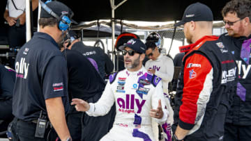 WATKINS GLEN, NY - JUNE 27: Jimmie Johnson talks with members of his team in the pits before the Sahlens Six Hours at the Glen IMSA race, June 27, 2021. (Photo by Brian Cleary/Getty Images)
