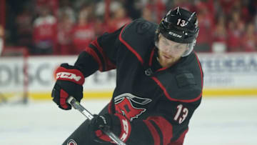 RALEIGH, NC - APRIL 22: Warren Foegele #13 of the Carolina Hurricanes shoots the puck during warmups prior to Game Six of the Eastern Conference First Round against the Washington Capitals during the 2019 NHL Stanley Cup Playoffs on April 22, 2019 at PNC Arena in Raleigh, North Carolina. (Photo by Gregg Forwerck/NHLI via Getty Images)