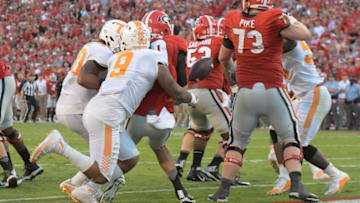 Oct 1, 2016; Athens, GA, USA; Tennessee Volunteers defensive end Derek Barnett (9) hits Georgia Bulldogs quarterback Jacob Eason (10) causing a fumble recovered by Tennessee for a touchdown during the fourth quarter at Sanford Stadium. Tennessee defeated Georgia 34-31. Mandatory Credit: Dale Zanine-USA TODAY Sports