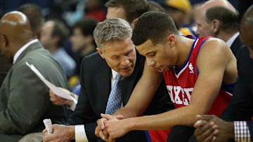 Feb 10, 2014; Oakland, CA, USA; Philadelphia 76ers head coach Brett Brown speaks to point guard Michael Carter-Williams (1) on the bench during the fourth quarter against the Golden State Warriors at Oracle Arena. The Golden State Warriors defeated the Philadelphia 76ers 123-80. Mandatory Credit: Kelley L Cox-USA TODAY Sports