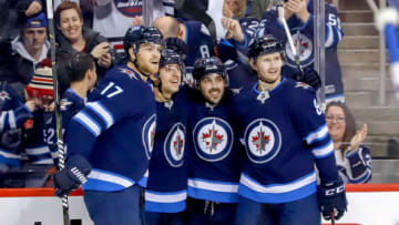 WINNIPEG, MB - DECEMBER 16: Adam Lowry #17, Brandon Tanev #13, Mathieu Perreault #85 and Jacob Trouba #8 of the Winnipeg Jets celebrate a second period goal against the Tampa Bay Lightning at the Bell MTS Place on December 16, 2018 in Winnipeg, Manitoba, Canada. (Photo by Darcy Finley/NHLI via Getty Images)