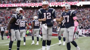 Oct 25, 2015; Foxborough, MA, USA; New England Patriots quarterback Tom Brady (12) celebrates with defensive end Chandler Jones (95) and tight end Rob Gronkowski (87) after throwing a touchdown pass during the fourth quarter against the New York Jets at Gillette Stadium. The New England Patriots won 30-23. Mandatory Credit: Greg M. Cooper-USA TODAY Sports