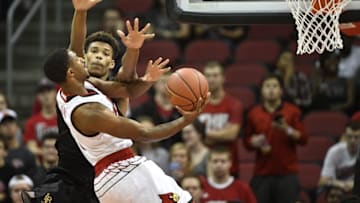 Nov 17, 2016; Louisville, KY, USA; Louisville Cardinals forward V.J. King (0) shoots against Long Beach State 49ers forward LaRond Williams (22) during the first half at KFC Yum! Center. Mandatory Credit: Jamie Rhodes-USA TODAY Sports