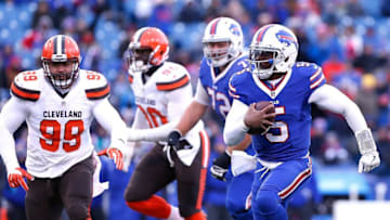 Dec 18, 2016; Orchard Park, NY, USA; Buffalo Bills quarterback Tyrod Taylor (5) runs with the ball as Cleveland Browns defensive tackle Stephen Paea (99) pursues during the second half at New Era Field. Bills beat the Browns 33-13. Mandatory Credit: Kevin Hoffman-USA TODAY Sports