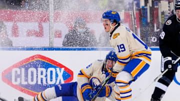Mar 13, 2022; Hamilton, Ontario, CAN; Buffalo Sabres forward Peyton Krebs (19) skates past a falling Buffalo Sabres defenseman Robert Hagg (8) during the third period against the Toronto Maple Leafs in the 2022 Heritage Classic ice hockey game at Tim Hortons Field. Mandatory Credit: John E. Sokolowski-USA TODAY Sports