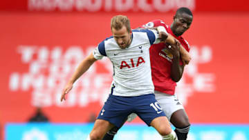 MANCHESTER, ENGLAND - OCTOBER 04: Harry Kane of Tottenham Hotspur battles for possession with Eric Bailly of Manchester United during the Premier League match between Manchester United and Tottenham Hotspur at Old Trafford on October 04, 2020 in Manchester, England. Sporting stadiums around the UK remain under strict restrictions due to the Coronavirus Pandemic as Government social distancing laws prohibit fans inside venues resulting in games being played behind closed doors. (Photo by Alex Livesey/Getty Images)