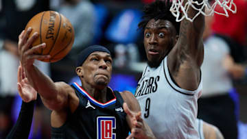 Apr 20, 2021; Portland, Oregon, USA; LA Clippers guard Rajon Rondo (4) shoots over Portland Trail Blazers forward Nassir Little (9) during the second quarter at the Moda Center. Mandatory Credit: Craig Mitchelldyer-USA TODAY Sports