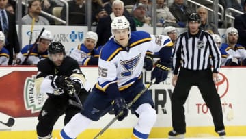 Nov 25, 2015; Pittsburgh, PA, USA; St. Louis Blues defenseman Colton Parayko (55) moves the puck as Pittsburgh Penguins center Matt Cullen (7) pressures during the third period at the CONSOL Energy Center. The Penguins won 4-3 in overtime. Mandatory Credit: Charles LeClaire-USA TODAY Sports