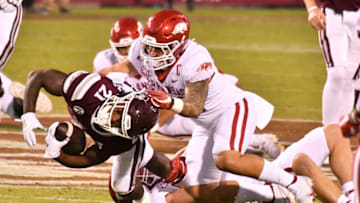Oct 3, 2020; Starkville, Mississippi, USA; Mississippi State Bulldogs running back Jo'quavious Marks (21) is tackled by Arkansas Razorbacks linebacker Grant Morgan (31) during the first quarter at Davis Wade Stadium at Scott Field. Mandatory Credit: Matt Bush-USA TODAY Sports
