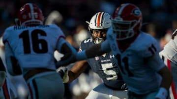 Auburn defensive lineman Derrick Brown (5) holds his position as Georgia quarterback Jake Fromm (11) hands the ball off to Georgia wide receiver Demetris Robertson (16) at Jordan-Hare Stadium in Auburn, Ala., on Saturday, Nov. 16, 2019. Georgia leads Auburn 14-0 at halftime.