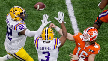 Jan 13, 2020; New Orleans, Louisiana, USA; Clemson Tigers quarterback Trevor Lawrence (16) passes against LSU Tigers safety JaCoby Stevens (3) and defensive end Neil Farrell Jr. (92) in the College Football Playoff national championship game at Mercedes-Benz Superdome. Mandatory Credit: Stephen Lew-USA TODAY Sports