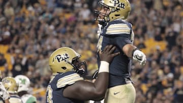 Oct 1, 2016; Pittsburgh, PA, USA; Pittsburgh Panthers offensive lineman Alex Officer (63) and running back James Conner (R) celebrate a four yard touchdown run by Conner against the Marshall Thundering Herd during the first quarter at Heinz Field. Mandatory Credit: Charles LeClaire-USA TODAY Sports