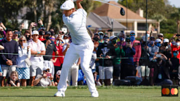 Mar 7, 2021; Orlando, Florida, USA; Bryson DeChambeau drives his ball over the lake on the sixth hole during the final round of the Arnold Palmer Invitational golf tournament at Bay Hill Club & Lodge. Mandatory Credit: Reinhold Matay-USA TODAY Sports