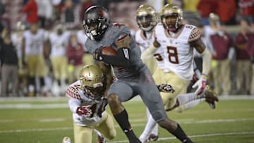 Oct 30, 2014; Louisville, KY, USA; Louisville Cardinals wide receiver DeVante Parker (9) runs the ball against Florida State Seminoles defensive back Lamarcus Brutus (42) during the second half at Papa John