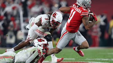 PASADENA, CALIFORNIA - JANUARY 01: Jaxon Smith-Njigba #11 of the Ohio State Buckeyes eludes the tackle of Vonte Davis #9 of the Utah Utes during the second half of the Rose Bowl game at Rose Bowl Stadium on January 01, 2022 in Pasadena, California. (Photo by Sean M. Haffey/Getty Images)