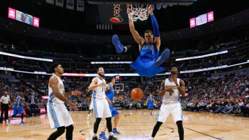 Mar 28, 2016; Denver, CO, USA; Dallas Mavericks forward Dwight Powell (7) dunks the ball against Denver Nuggets guard Gary Harris (14) and center Joffrey Lauvergne (77) and guard JaKarr Sampson (9) in the fourth quarter at the Pepsi Center. The Mavericks defeated the Nuggets 97-88. Mandatory Credit: Isaiah J. Downing-USA TODAY Sports