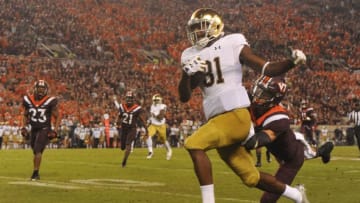 BLACKSBURG, VA - OCTOBER 6: Wide receiver Miles Boykin #81 of the Notre Dame Fighting Irish evades the tackle from defensive back Caleb Farley #3 of the Virginia Tech Hokies and scores a touchdown in the second half at Lane Stadium on October 6, 2018 in Blacksburg, Virginia. (Photo by Michael Shroyer/Getty Images)