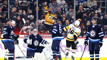 Nov 22, 2021; Winnipeg, Manitoba, CAN; Pittsburgh Penguins left wing Jason Zucker (16) celebrates his second period goal on Winnipeg Jets goaltender Connor Hellebuyck (37) at Canada Life Centre. Mandatory Credit: James Carey Lauder-USA TODAY Sports