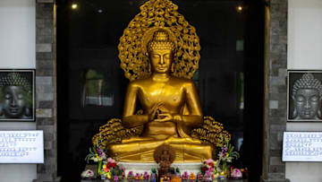 SURABAYA, INDONESIA - MAY 26: An Indonesian Buddhist monk lights incense during Vesak Day at Buddhayana Dharmawira Centre on May 26, 2021 in Surabaya, Indonesia. Buddhists celebrated Vesak Day on Wednesday - an auspicious day that commemorates the birth, enlightenment to Nirvana, and death of Gautama Buddha, whose teachings form the Buddhist religion. (Photo by Robertus Pudyanto/Getty Images)