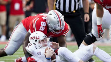 Sep 19, 2015; Columbus, OH, USA; Northern Illinois Huskies quarterback Drew Hare (12) is sacked by Ohio State Buckeyes defensive lineman Adolphus Washington (92) at Ohio Stadium. Ohio State won the game 20-13. Mandatory Credit: Greg Bartram-USA TODAY Sports
