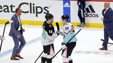 Feb 4, 2023; Sunrise, Florida, USA; Atlantic Division forward Nick Suzuki (14) of the Montreal Canadiens and Central Division forward Nathan MacKinnon (29) of the Colorado Avalanche shake hands after the final during the 2023 NHL All-Star Game at FLA Live Arena. Mandatory Credit: Sam Navarro-USA TODAY Sports