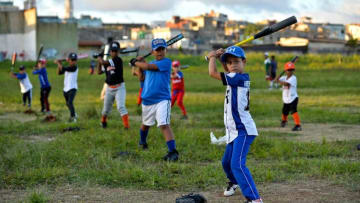 Cuban children practice baseball in a field of Havana, on September 17, 2018. - Football took over baseball in the preference of children and young people in Cuba, where the latter has been king for almost 150 years. (Photo by Yamil LAGE / AFP) (Photo credit should read YAMIL LAGE/AFP/Getty Images)