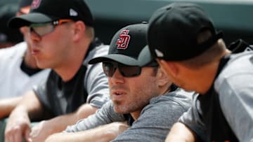 SARASOTA, FL - FEBRUARY 23: Baltimore Orioles players look on while wearing Stoneman Douglas High School baseball caps to honor the 17 people killed earlier this month during a mass shooting prior to a Grapefruit League spring training game against the Tampa Bay Rays at Ed Smith Stadium on February 23, 2018 in Sarasota, Florida. (Photo by Joe Robbins/Getty Images)