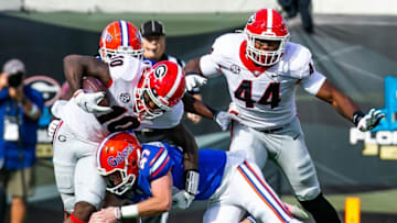 Florida Gators place kicker Jace Christmann (47) makes a touchdown saving tackles on Georgia Bulldogs wide receiver Kearis Jackson (10). The Florida Gators played the Georgia Bulldogs in the first half Saturday afternoon, October 30, 2021 at TIAA Bank Field in Jacksonville, FL. [Doug Engle/Gainesville Sun]2021Flgai 103021 Bulldogsvsgators