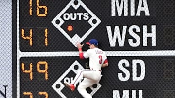 May 15, 2016; Philadelphia, PA, USA; Philadelphia Phillies left fielder David Lough (3) crashes into the wall in right field during the second inning against the Cincinnati Reds at Citizens Bank Park. Mandatory Credit: Eric Hartline-USA TODAY Sports