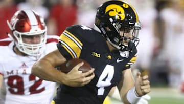 IOWA CITY, IOWA- AUGUST 31: Quarterback Nate Stanley #4 of the Iowa Hawkeyes scrambles on a keeper in the first half past defensive lineman Austin Ertl #92 of the Miami Ohio RedHawks on August 31, 2019 at Kinnick Stadium in Iowa City, Iowa. (Photo by Matthew Holst/Getty Images)