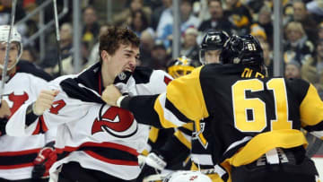 Dec 23, 2016; Pittsburgh, PA, USA; New Jersey Devils left wing Miles Wood (44) and Pittsburgh Penguins defenseman Steve Oleksy (61) fight during the second period at the PPG PAINTS Arena. Mandatory Credit: Charles LeClaire-USA TODAY Sports