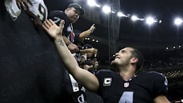 Sep 11, 2016; New Orleans, LA, USA; Oakland Raiders quarterback Derek Carr (4) celebrates after a win against the New Orleans Saints during a game at the Mercedes-Benz Superdome. The Raiders defeated the Saints 35-34. Mandatory Credit: Derick E. Hingle-USA TODAY Sports