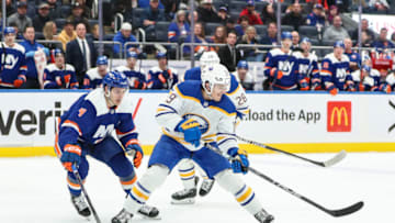 Mar 25, 2023; Elmont, New York, USA; Buffalo Sabres center Peyton Krebs (19) and New York Islanders defenseman Samuel Bolduc (4) chase the puck in the first period at UBS Arena. Mandatory Credit: Wendell Cruz-USA TODAY Sports