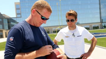 FRISCO, TX - MAY 30: Dallas Cowboys Head Coach Jason Garrett autographs a football for reigning Indianapolis 500 Champion Will Power after practice at The Ford Center at The Star on May 30, 2018 in Frisco, Texas. (Photo by Richard Rodriguez/Getty Images)